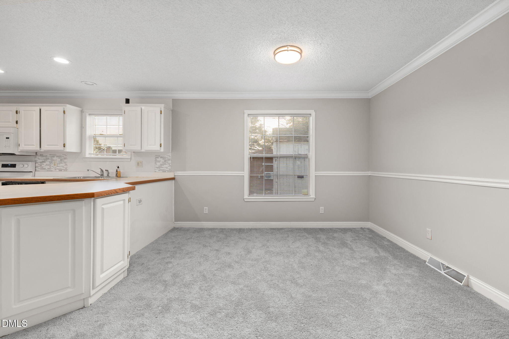 2850 Sanderford Road Raleigh, NC 27610 - Photo 13 of 34 a kitchen with a sink cabinets and window