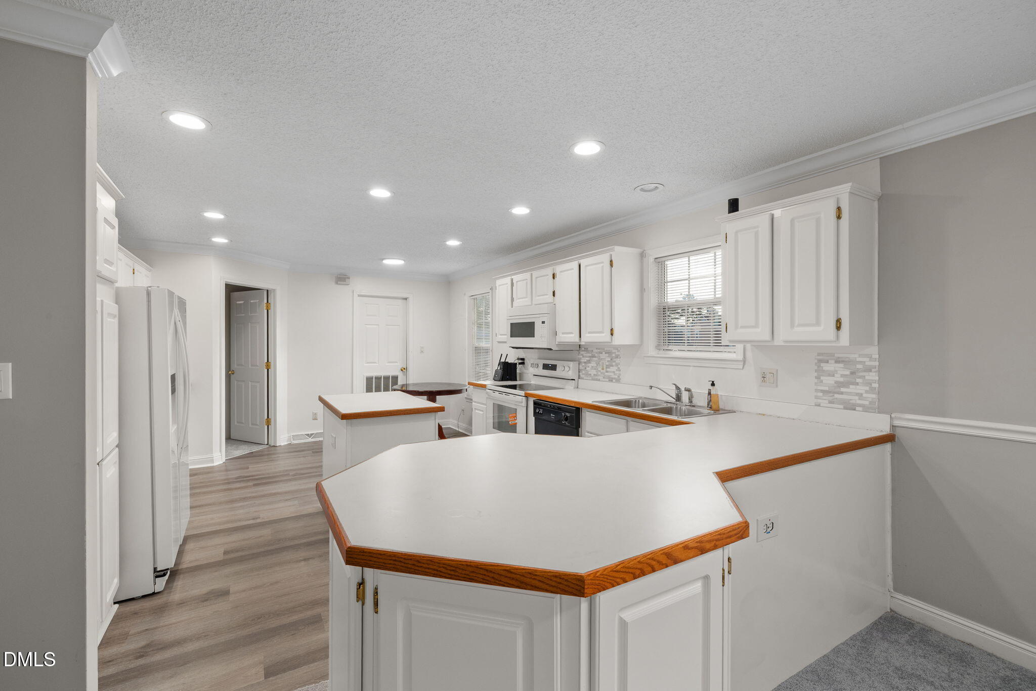 2850 Sanderford Road Raleigh, NC 27610 - Photo 14 of 34 a kitchen with white cabinets and sink
