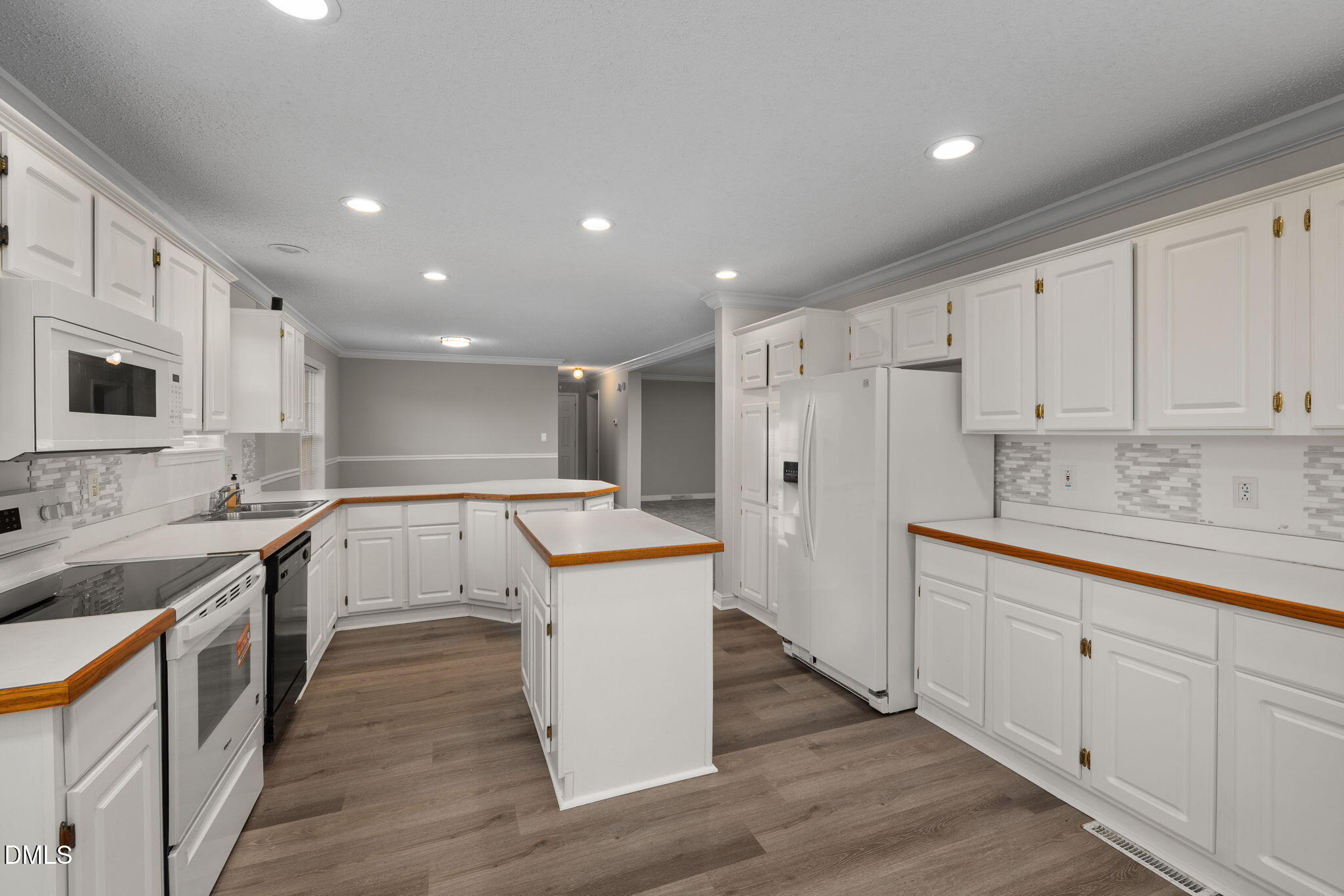 2850 Sanderford Road Raleigh, NC 27610 - Photo 17 of 34 a kitchen with a sink stove and white cabinets