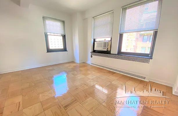 108 East 38th Street, Unit 310 Manhattan, NY 10016 - Photo 2 of 6 a view of an empty room with window