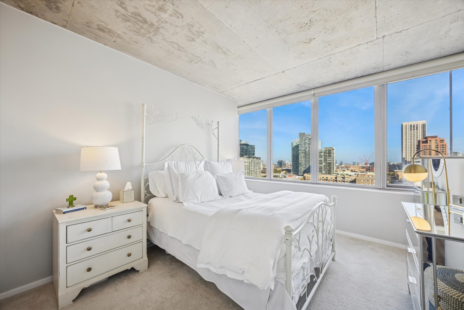 659 West Randolph Street, Unit 1401 Chicago, IL 60661 - Photo 11 of 15 a bedroom with a bed and a cabinets