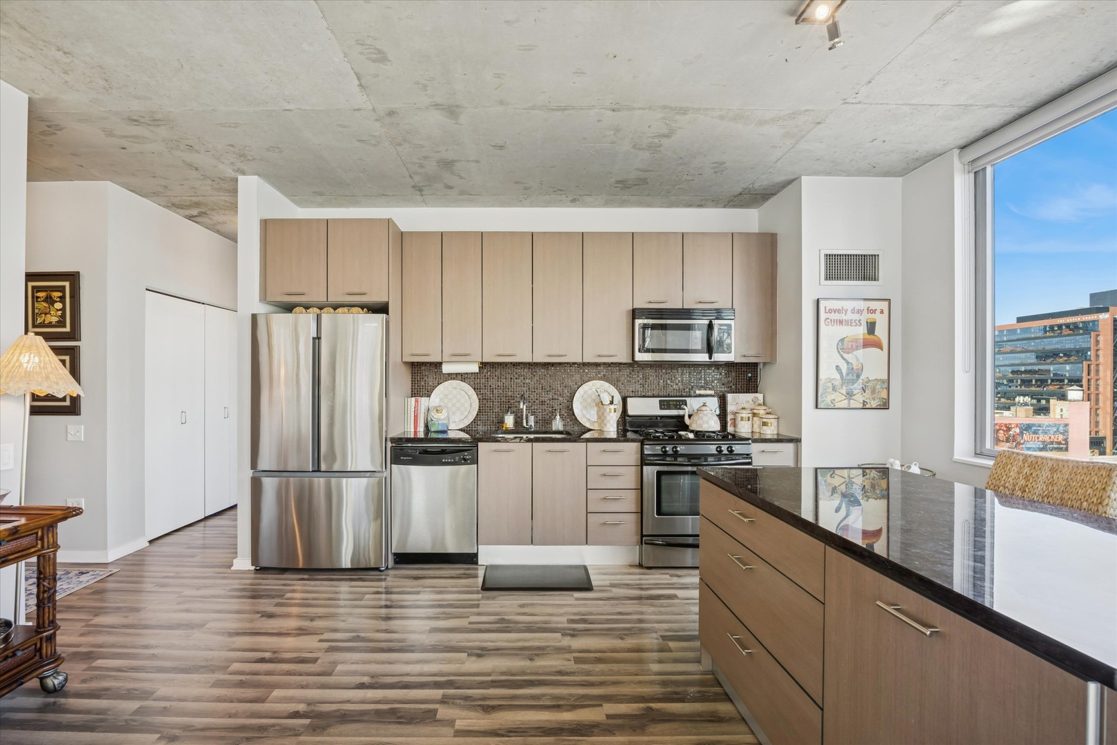 659 West Randolph Street, Unit 1401 Chicago, IL 60661 - Photo 4 of 15 a kitchen with granite countertop a refrigerator stove top oven and sink