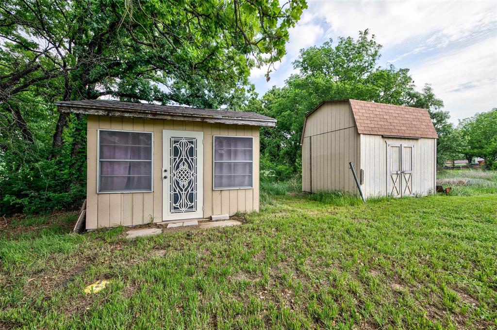 514 Gilliland Road Springtown, TX 76082 - Photo 26 of 31 Craft room shed on the left, and storage shed on the right