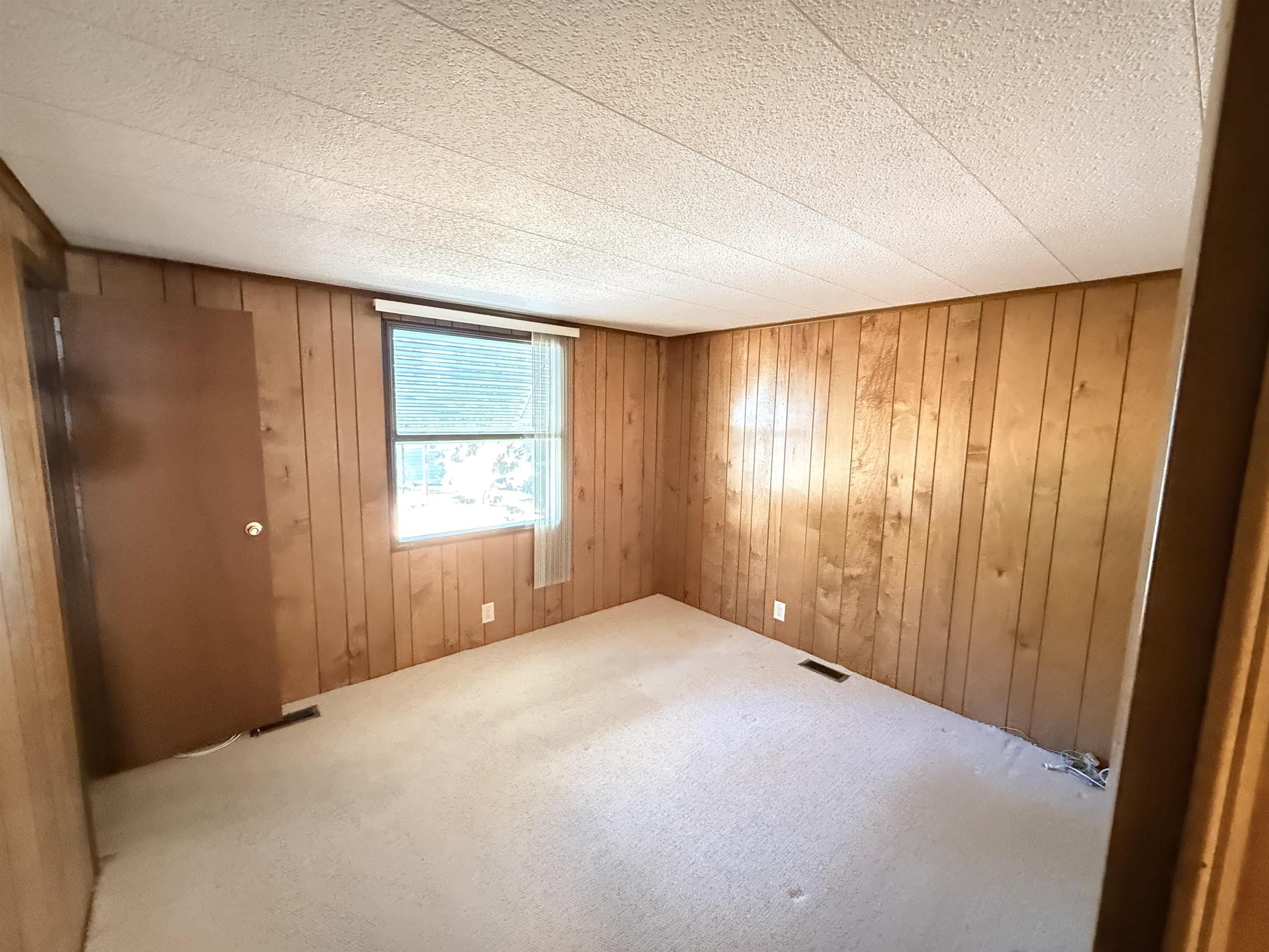 3043 Atlanta Circle Murrells Inlet, SC 29576 - Photo 19 of 36 Carpeted spare room featuring wood walls