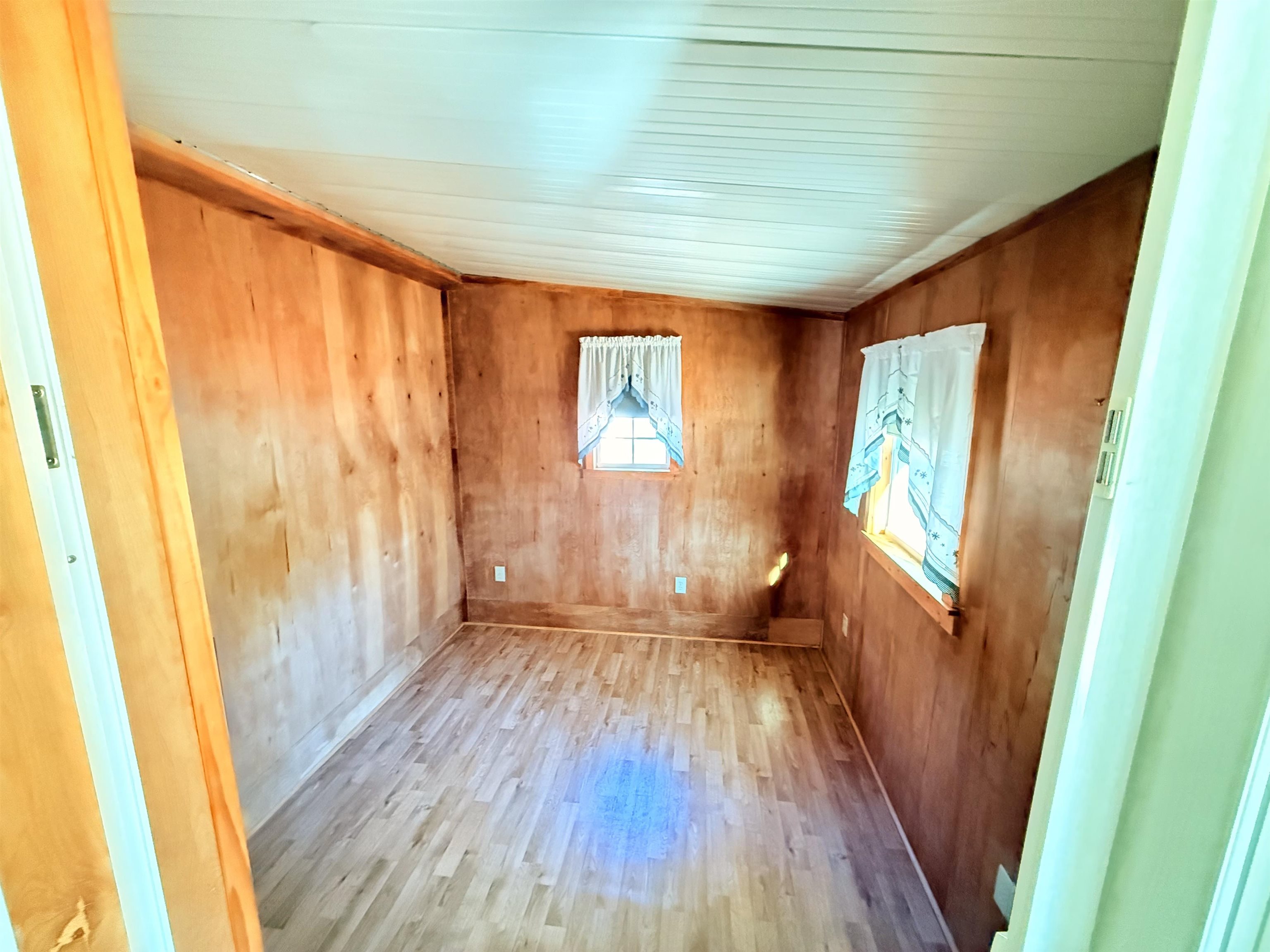 3043 Atlanta Circle Murrells Inlet, SC 29576 - Photo 24 of 36 Empty room featuring wood finished floors, wood walls, and vaulted ceiling