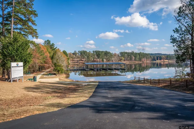 a view of a terrace with chairs and wooden fence