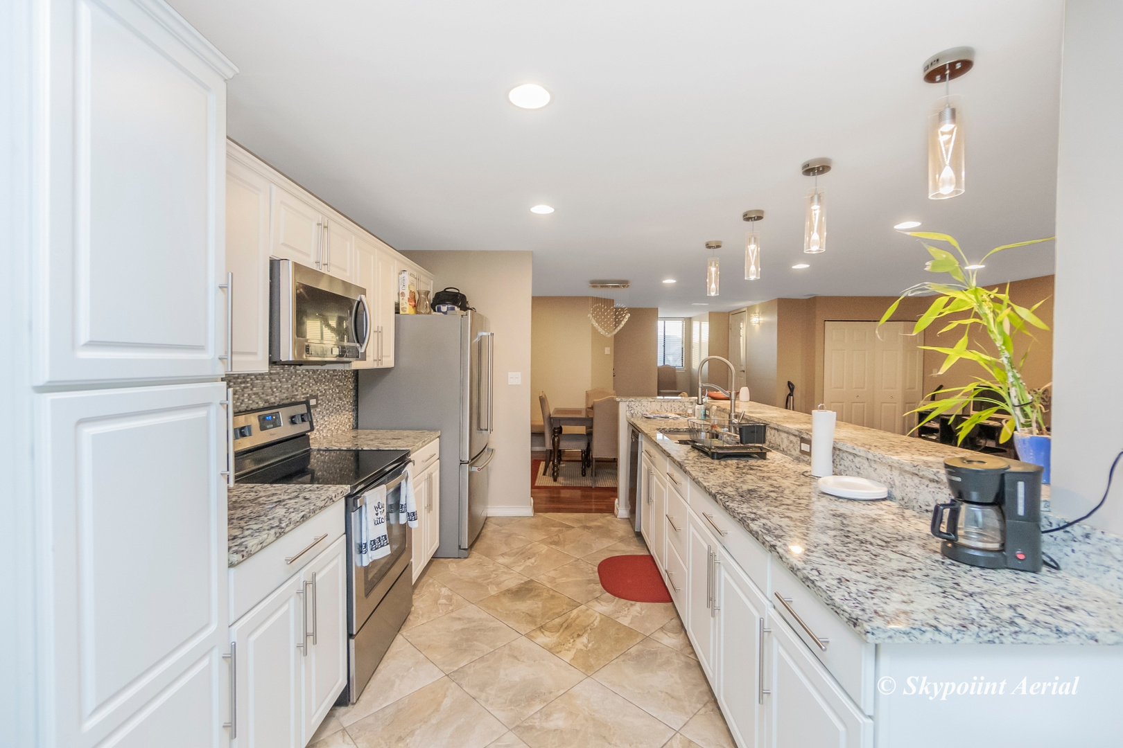 3231 West 184th Street, Unit 2B Homewood, IL 60430 - Photo 5 of 22 a large kitchen with stainless steel appliances granite countertop a lot of counter space and wooden floor