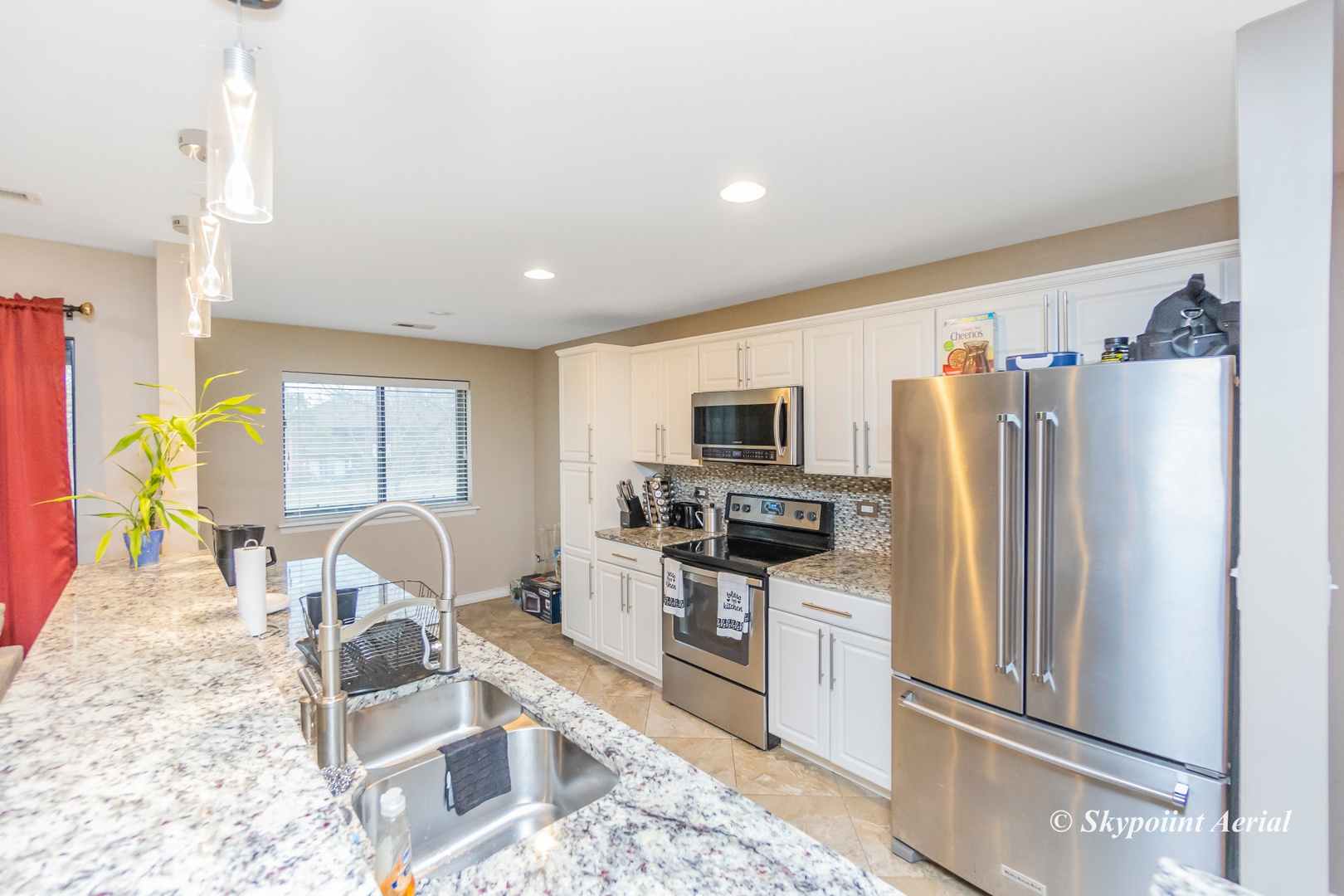 3231 West 184th Street, Unit 2B Homewood, IL 60430 - Photo 6 of 22 a kitchen with stainless steel appliances granite countertop a refrigerator and a stove top oven
