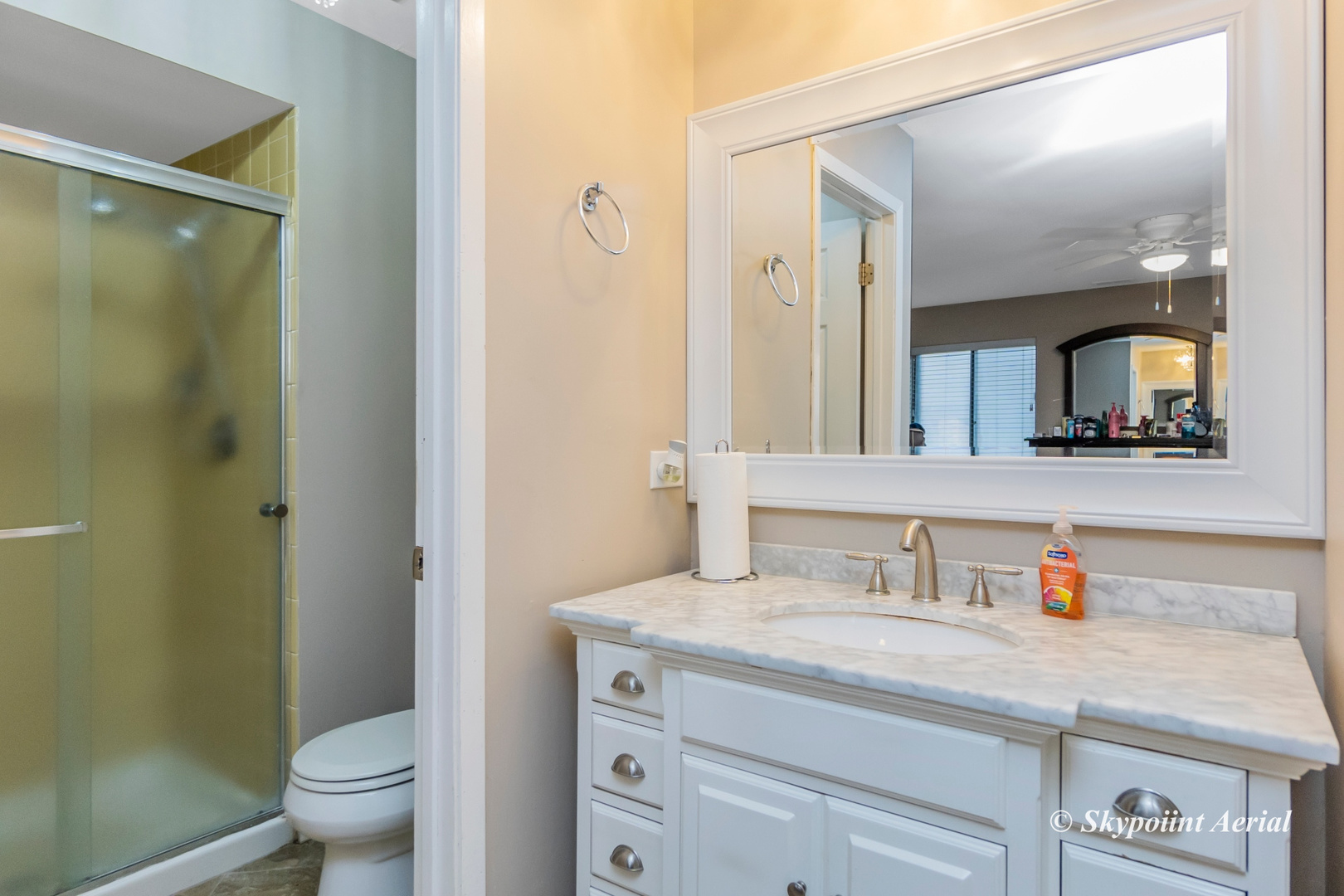 3231 West 184th Street, Unit 2B Homewood, IL 60430 - Photo 10 of 22 a bathroom with a granite countertop sink a toilet and a mirror