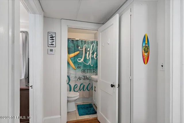 a view of balcony with wooden floor and potted plants