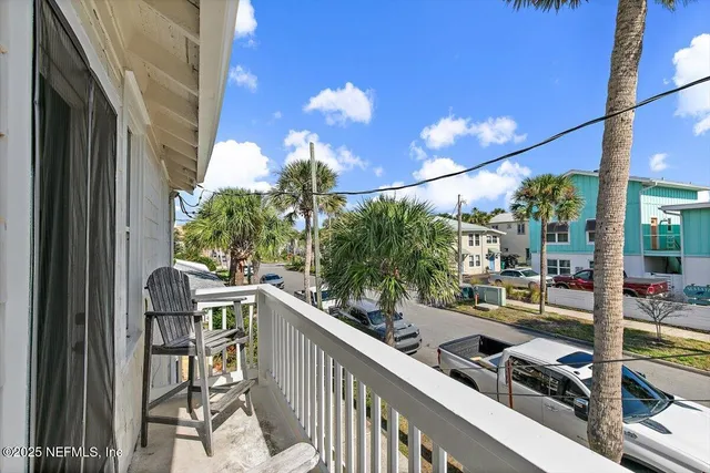 a room with furniture a refrigerator and flowers