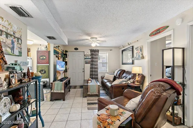 a utility room with fridge and wooden floor
