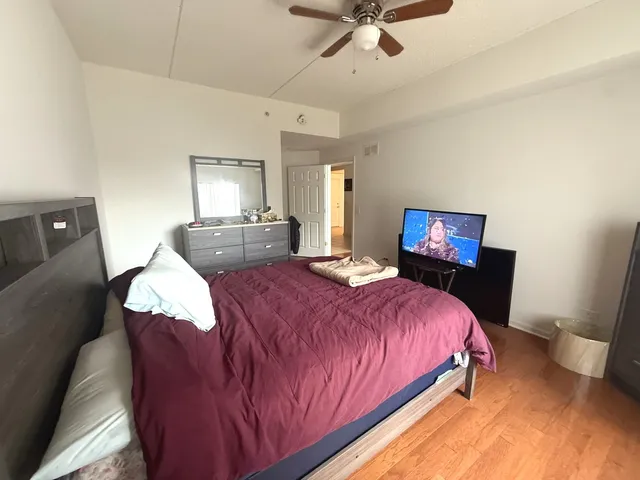 a bedroom with a bed mirror and window