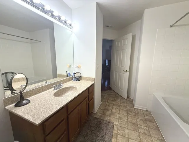 a bathroom with a sink a vanity and a mirror