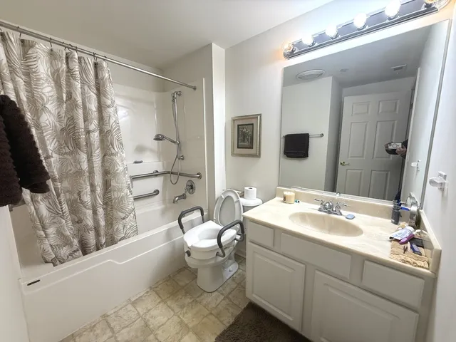 a spacious bathroom with a sink a toilet and shower