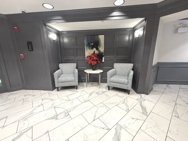 a living room with furniture and flowers