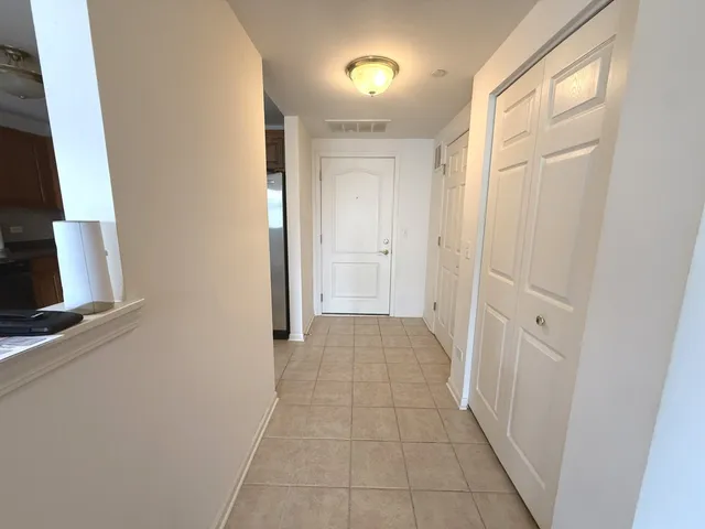 a view of a hallway to rooms