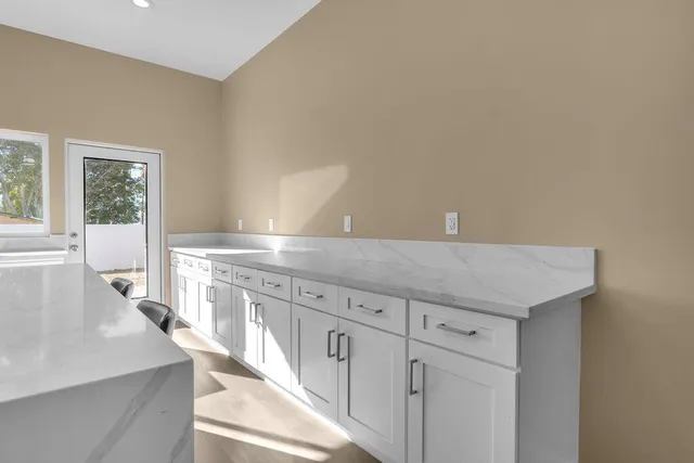 a view of a kitchen with granite countertop cabinets