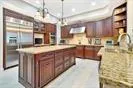 a kitchen with stainless steel appliances granite countertop a sink a counter space and cabinets