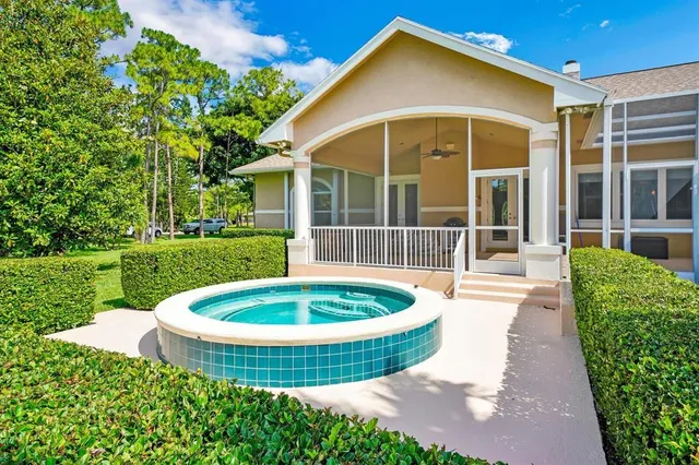 a view of a house with a swimming pool and a yard