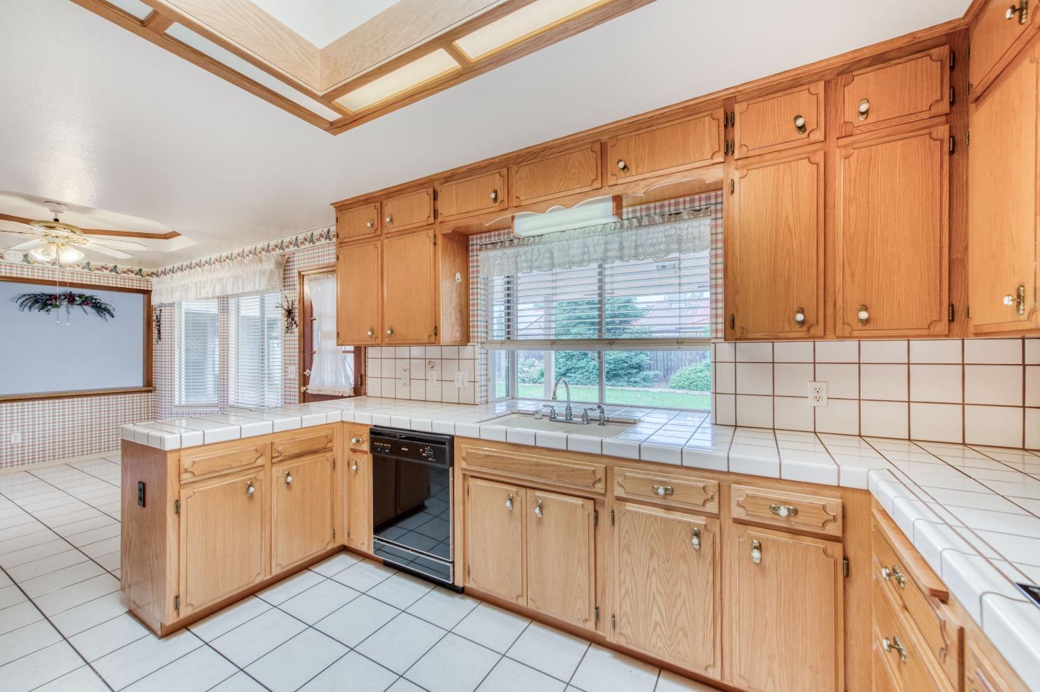 2530 Sterling Avenue Sanger, CA 93657 - Photo 11 of 40 a kitchen with cabinets appliances a sink and a window
