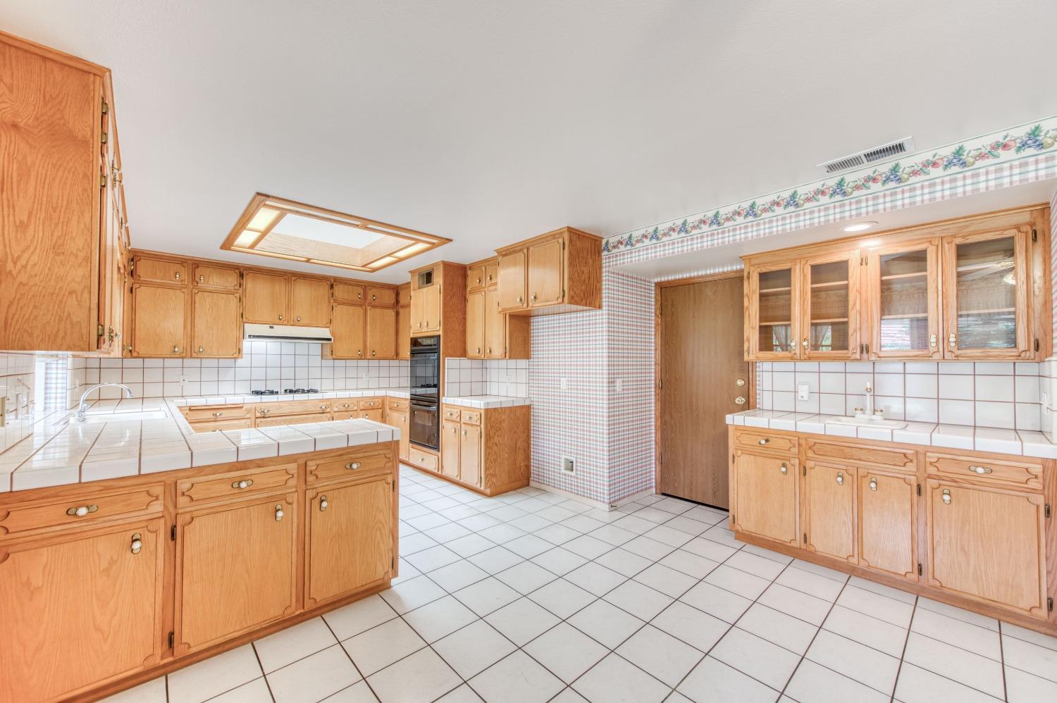 2530 Sterling Avenue Sanger, CA 93657 - Photo 13 of 40 a kitchen with a sink stove and cabinets
