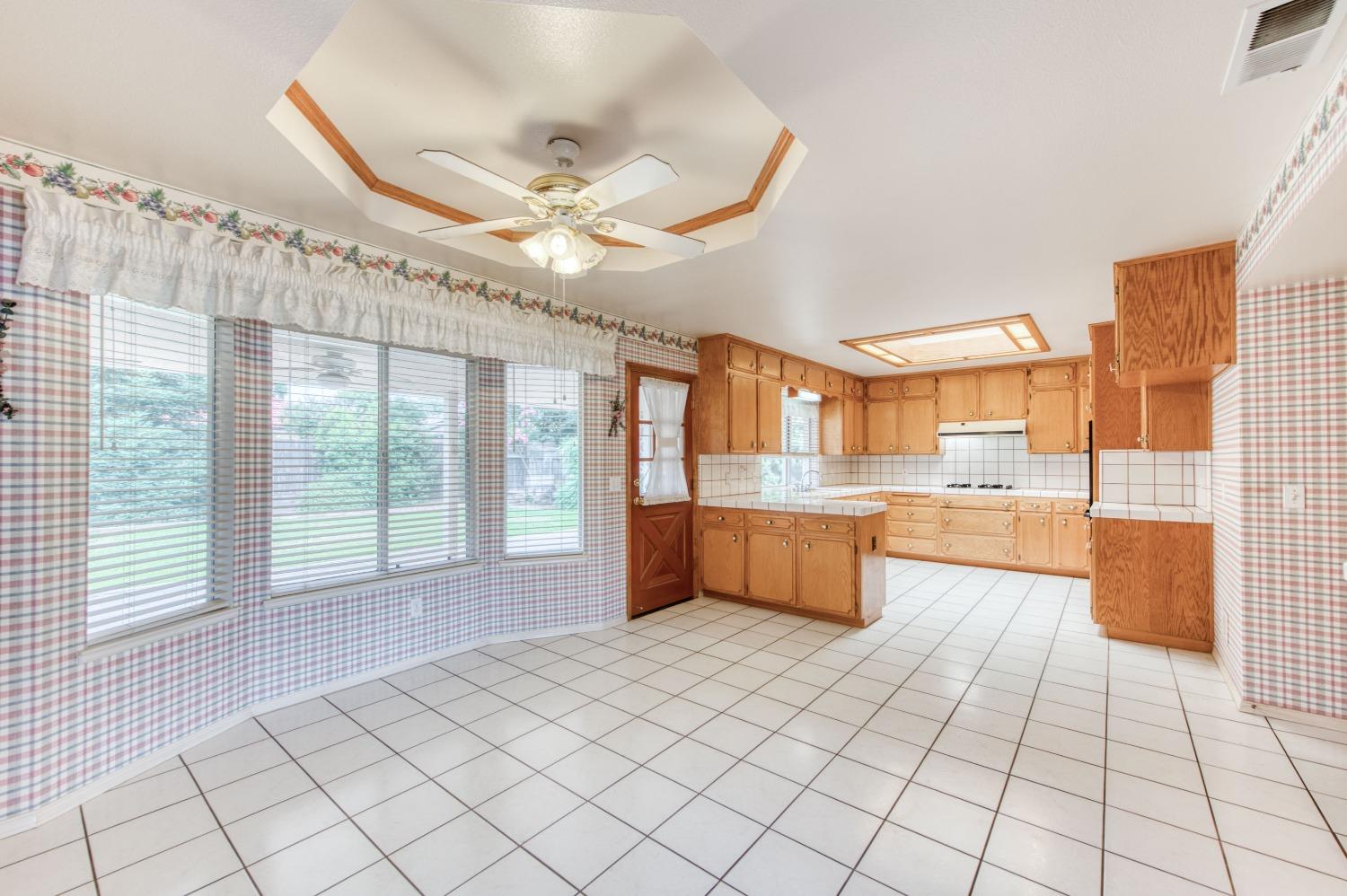 2530 Sterling Avenue Sanger, CA 93657 - Photo 17 of 40 a large white kitchen with a large window and kitchen view