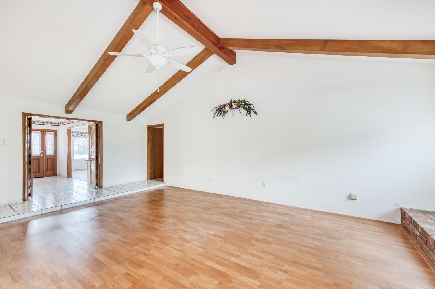 2530 Sterling Avenue Sanger, CA 93657 - Photo 19 of 40 a view of an empty room with wooden floor and a window