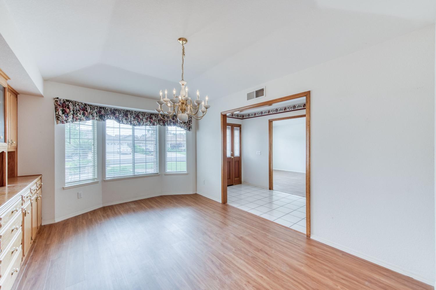 2530 Sterling Avenue Sanger, CA 93657 - Photo 22 of 40 a view of an empty room with wooden floor and a window