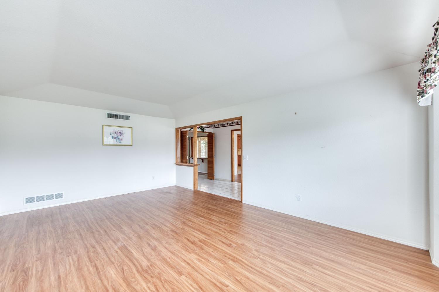 2530 Sterling Avenue Sanger, CA 93657 - Photo 23 of 40 a view of an empty room with wooden floor