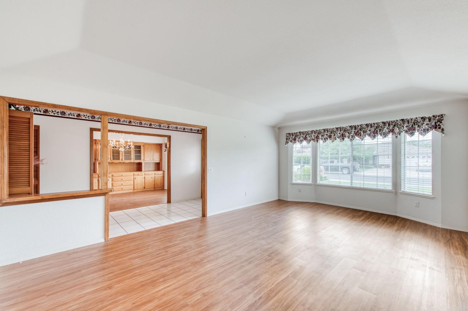 2530 Sterling Avenue Sanger, CA 93657 - Photo 24 of 40 a view of an empty room with wooden floor and a window