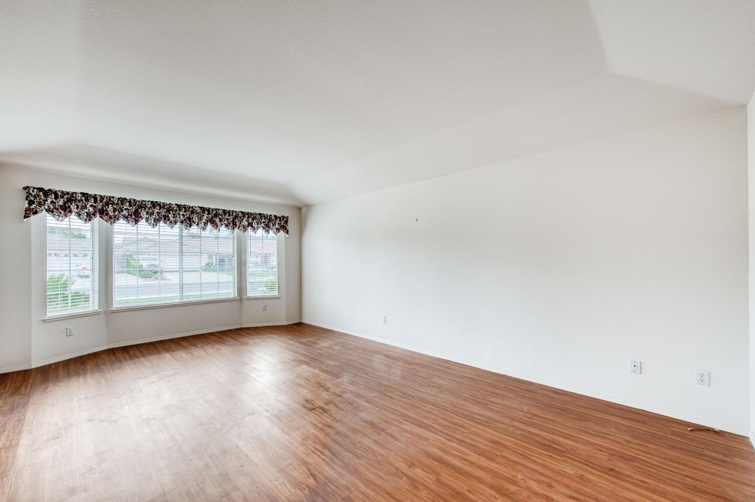 2530 Sterling Avenue Sanger, CA 93657 - Photo 25 of 40 an empty room with wooden floor and windows