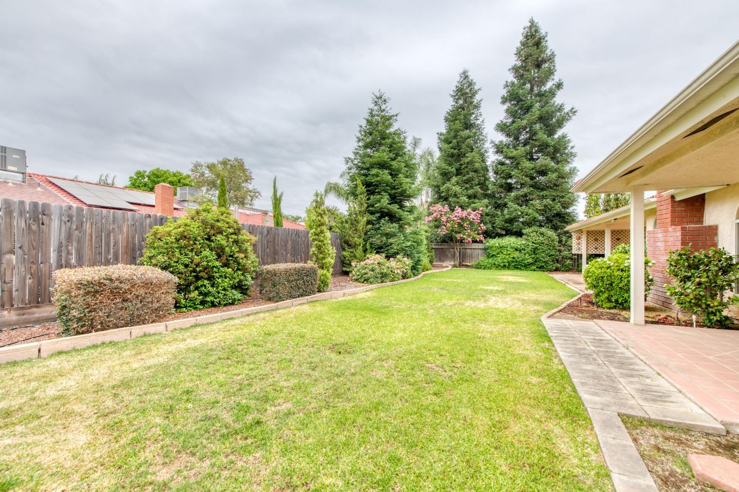 2530 Sterling Avenue Sanger, CA 93657 - Photo 27 of 40 a view of backyard with swimming pool and trees in the background