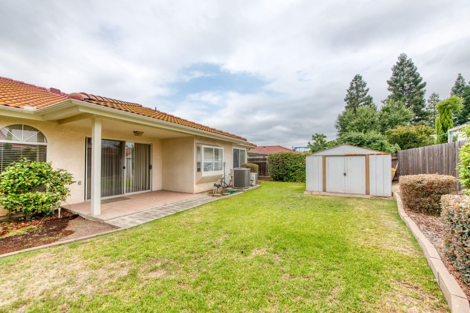 2530 Sterling Avenue Sanger, CA 93657 - Photo 29 of 40 a front view of a house with a yard and garage