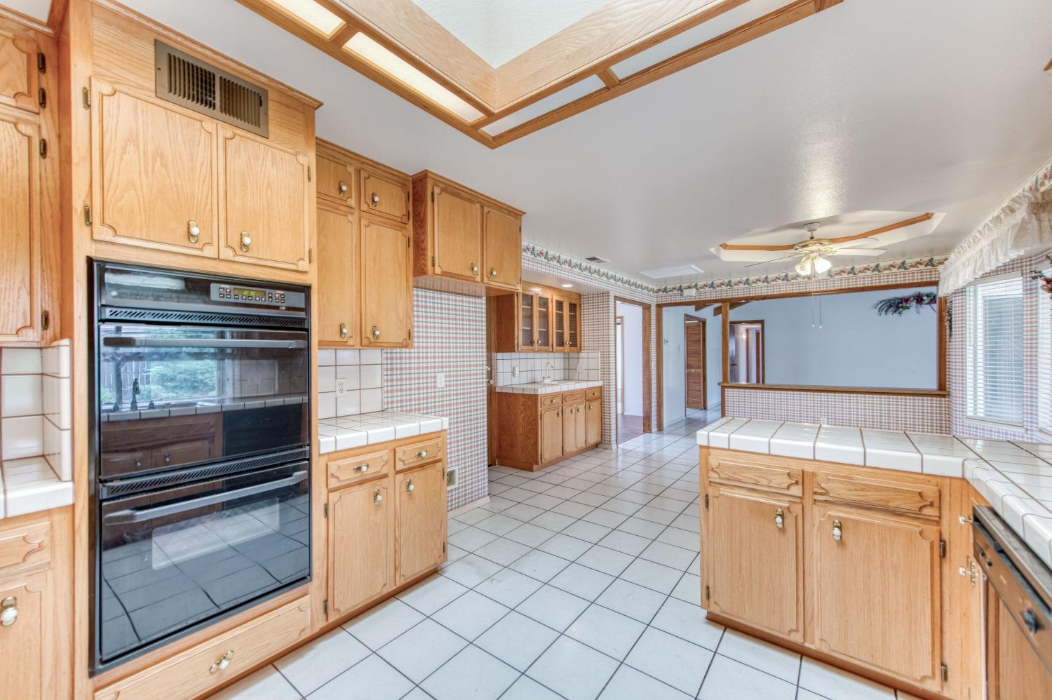 2530 Sterling Avenue Sanger, CA 93657 - Photo 3 of 40 a kitchen with white cabinets and white appliances