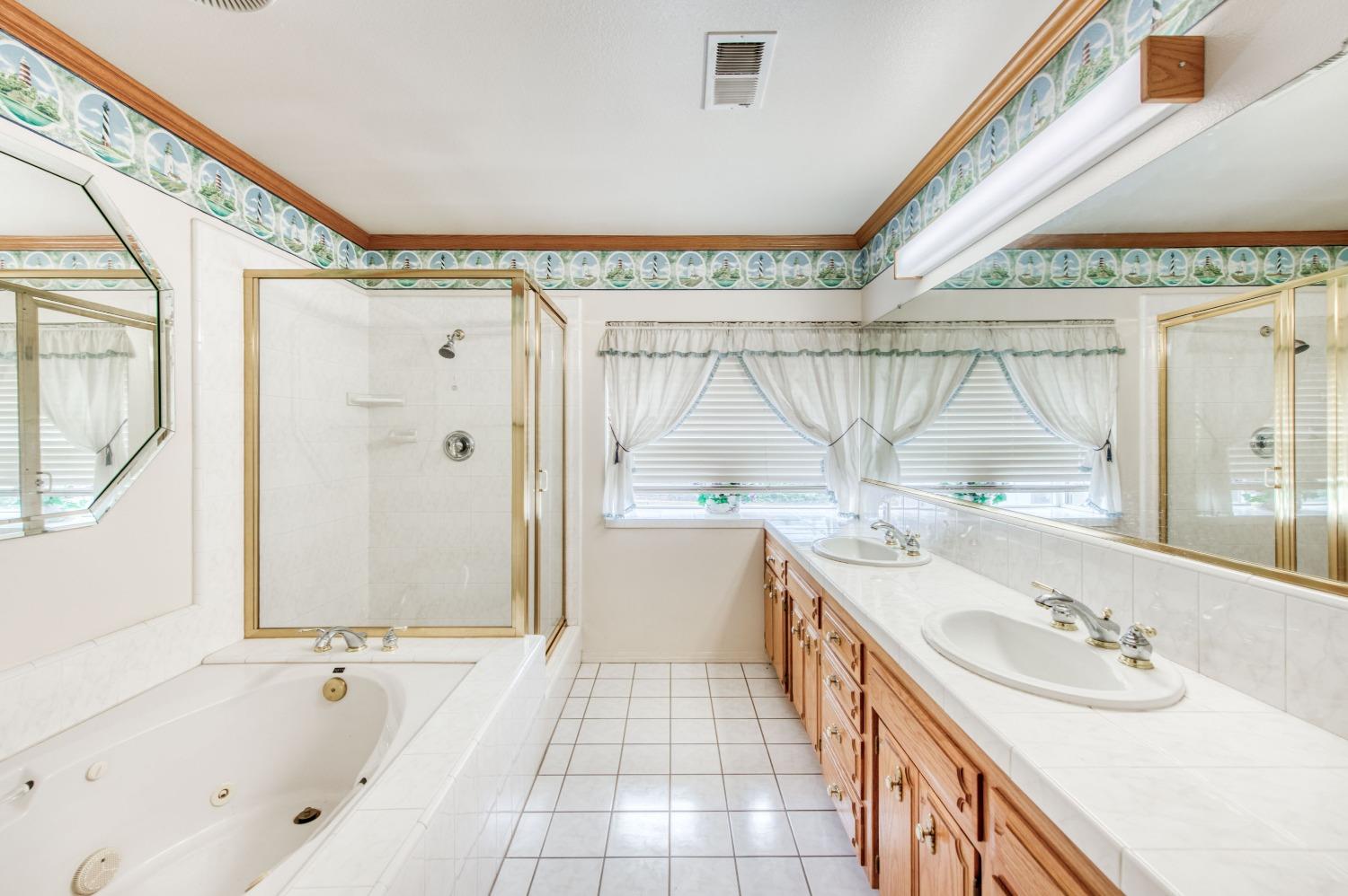 2530 Sterling Avenue Sanger, CA 93657 - Photo 4 of 40 a bathroom with a granite countertop double vanity sink a mirror and a bathtub