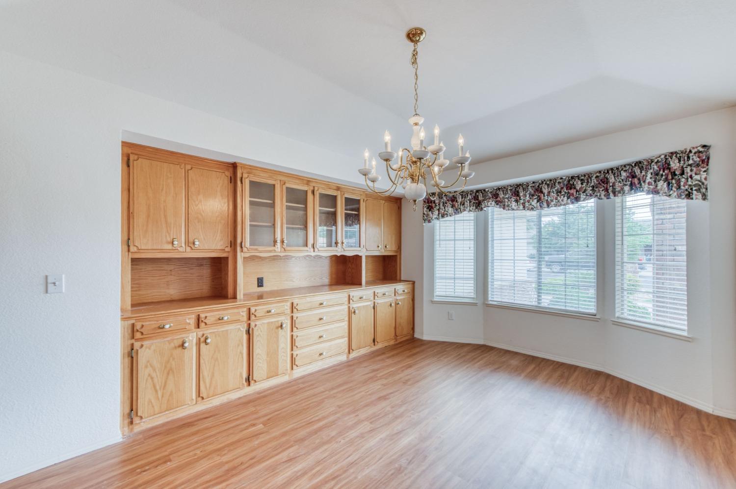 2530 Sterling Avenue Sanger, CA 93657 - Photo 5 of 40 a large kitchen with stainless steel appliances granite countertop a oven a stove cabinets and a dining table