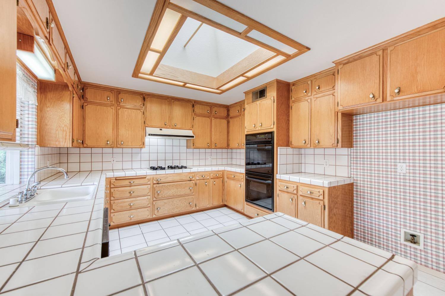 2530 Sterling Avenue Sanger, CA 93657 - Photo 9 of 40 a kitchen with stainless steel appliances kitchen island granite countertop a sink and cabinets
