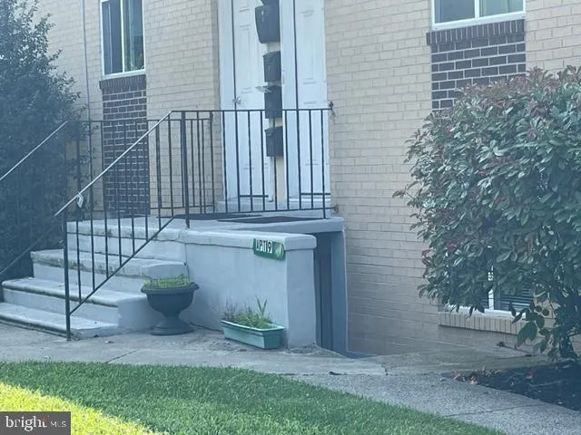 a view of a house with a small yard and plants