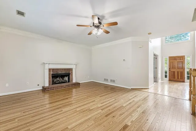 wooden floor in an empty room with a fireplace