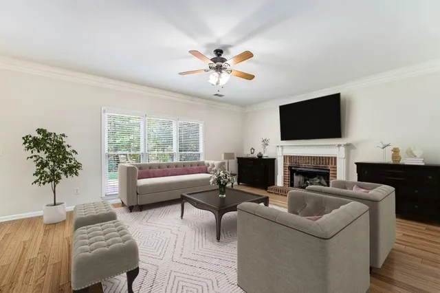 a living room with furniture a fireplace and a flat screen tv