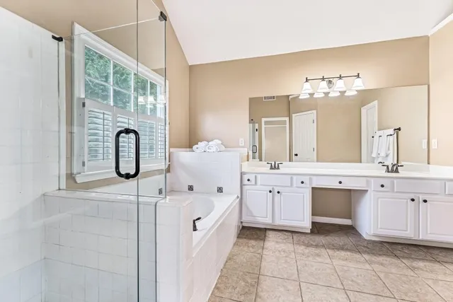 a bathroom with a sink vanity and mirror