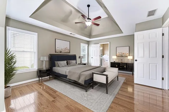 a spacious bedroom with a bed couch and a window