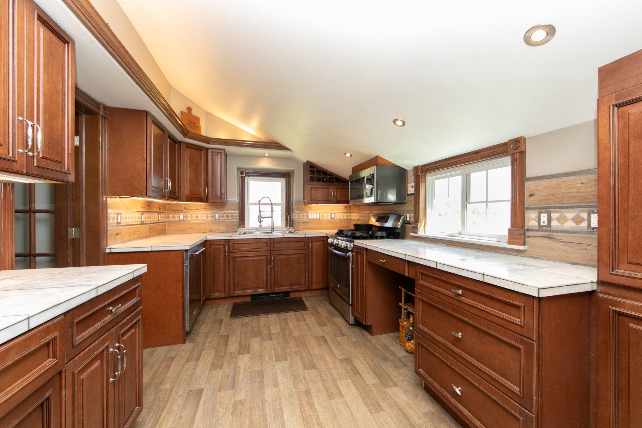 128 Jefferson Road Elmer, NJ 08318 - Photo 12 of 47 a large kitchen with stainless steel appliances granite countertop a lot of counter space and a sink
