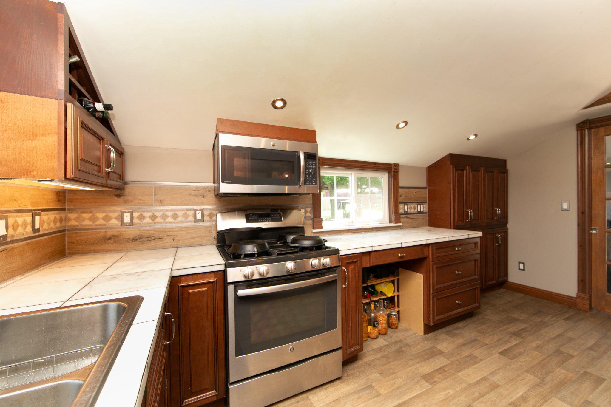 128 Jefferson Road Elmer, NJ 08318 - Photo 13 of 47 a kitchen with stainless steel appliances stove microwave and cabinets