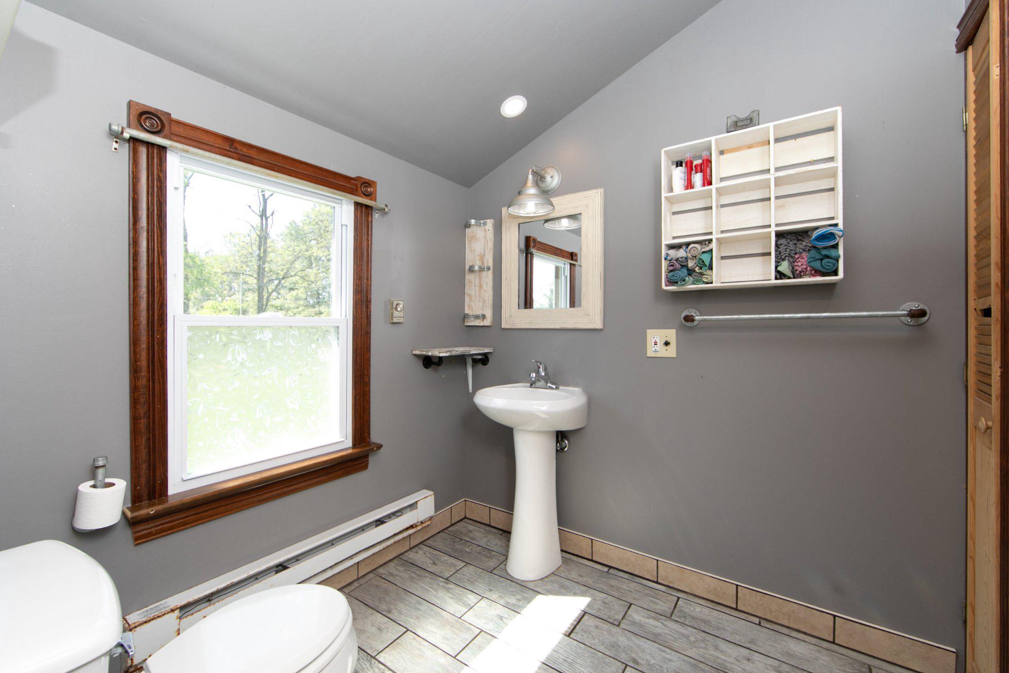 128 Jefferson Road Elmer, NJ 08318 - Photo 18 of 47 a bathroom with a sink a mirror and a window