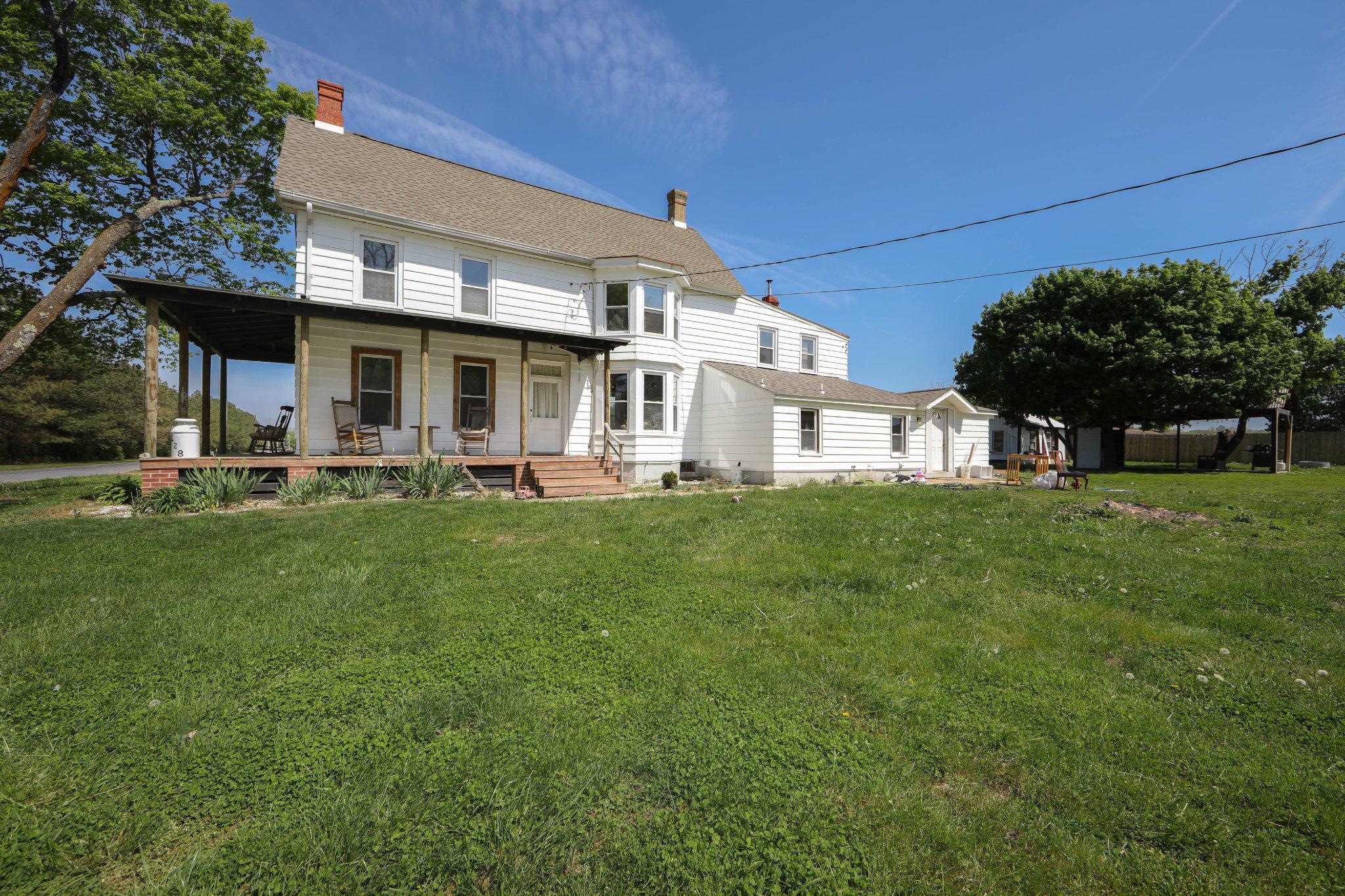 128 Jefferson Road Elmer, NJ 08318 - Photo 2 of 47 a front view of a house with a garden and plants