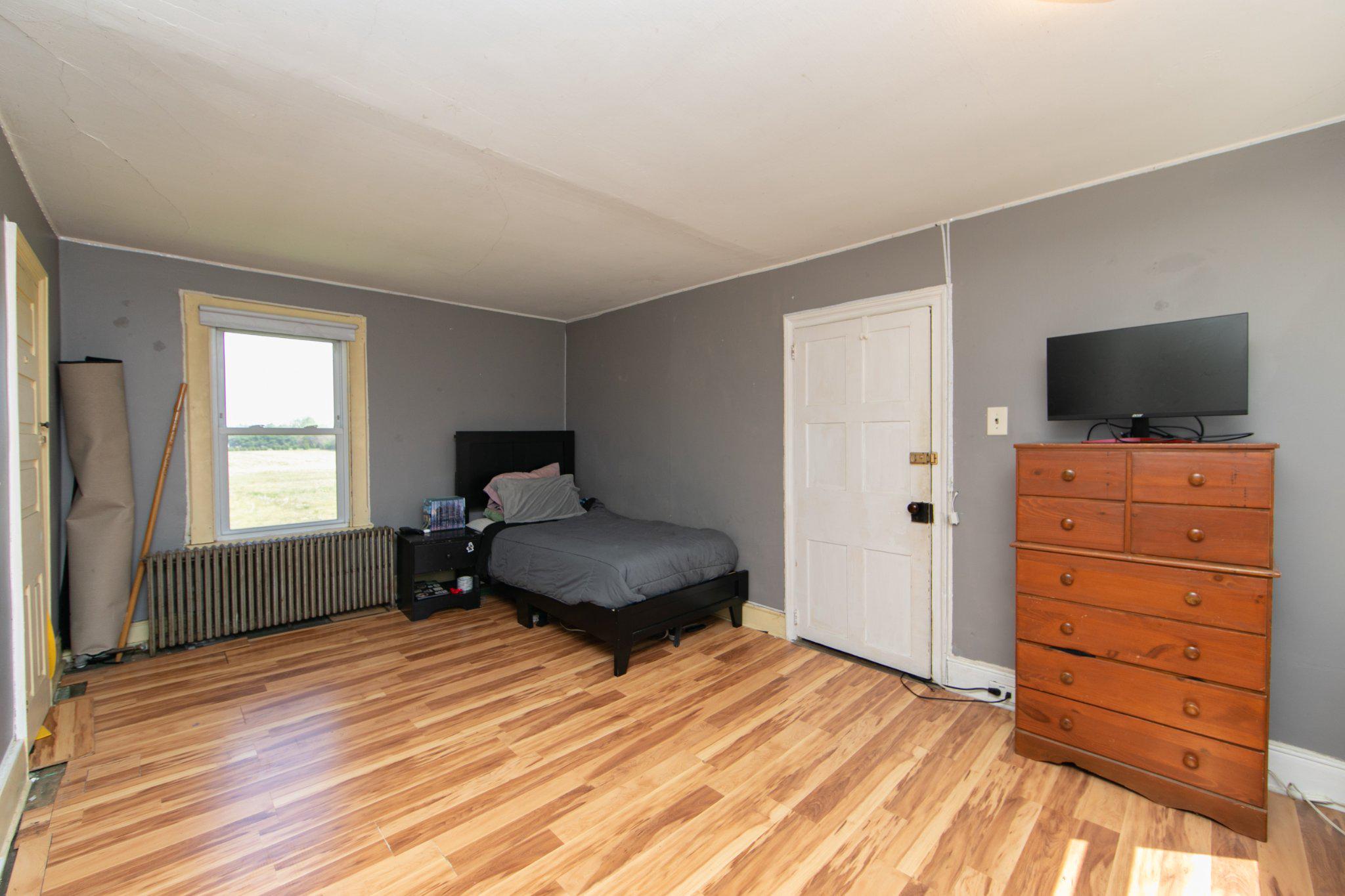 128 Jefferson Road Elmer, NJ 08318 - Photo 24 of 47 a bedroom with a bed and wooden floor