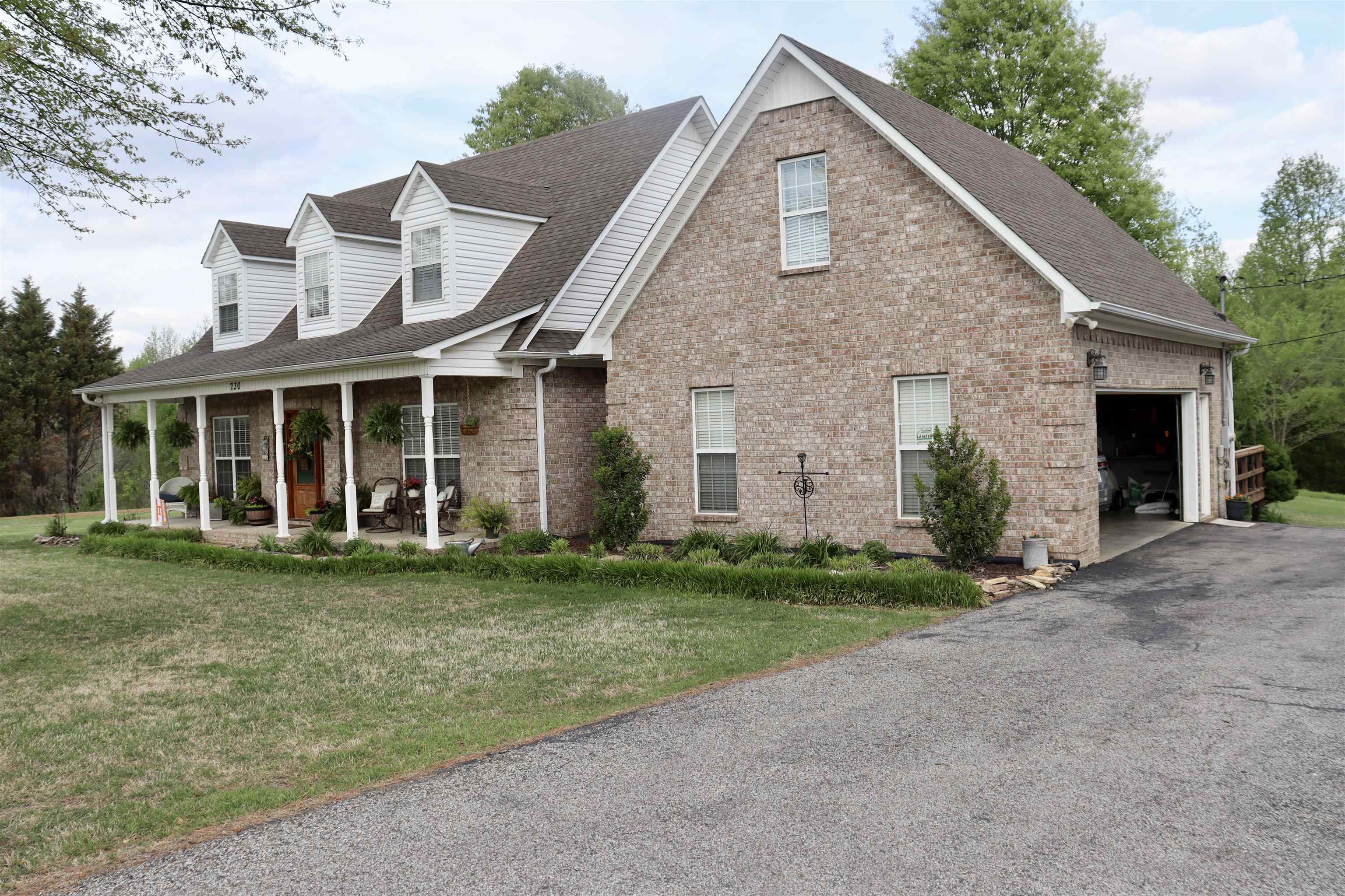 730 Durhamville Road Ripley, TN 38063 - Photo 29 of 40 a front view of a house with a yard and garage