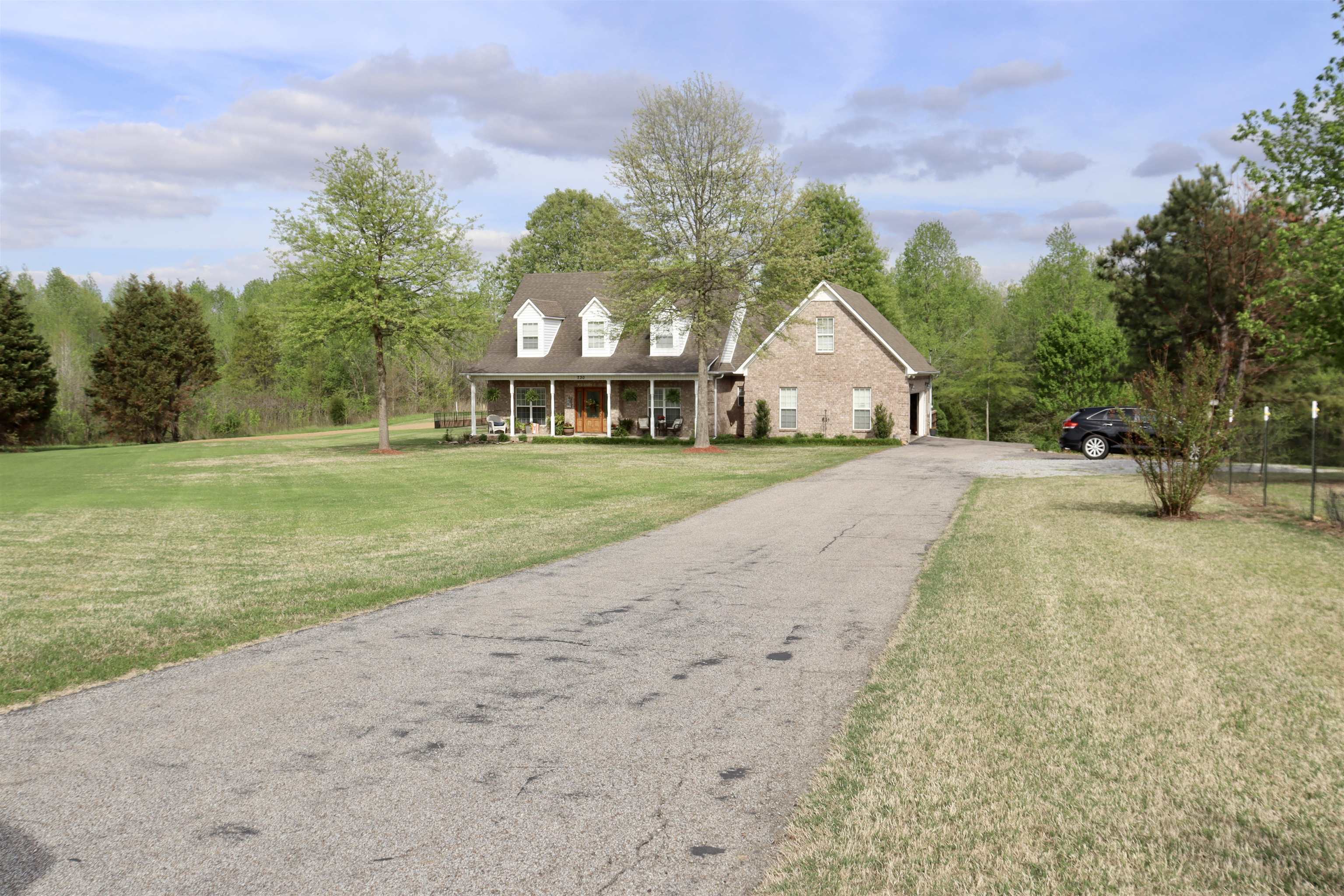 730 Durhamville Road Ripley, TN 38063 - Photo 32 of 40 a front view of a house with a yard and garage